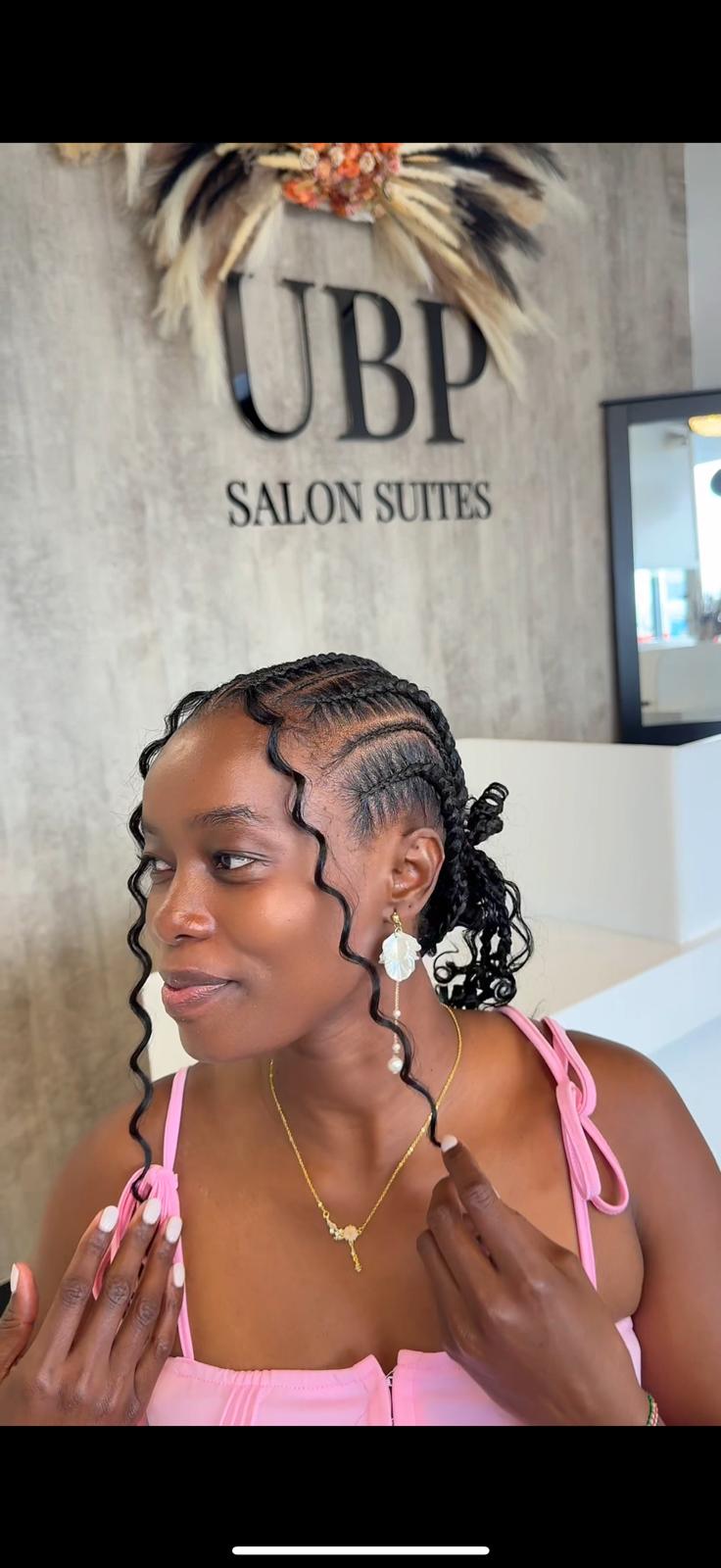 Braided salon style with curly face-framing pieces
